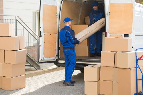 Removal team beginning a house move with packed boxes