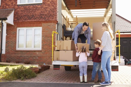 Professional office relocation services in Maidavale with movers handling packed office equipment