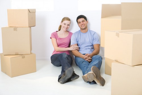 Team of house removalists in Maidavale carrying a sofa safely