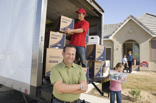 Removal team carrying boxes safely during a house move