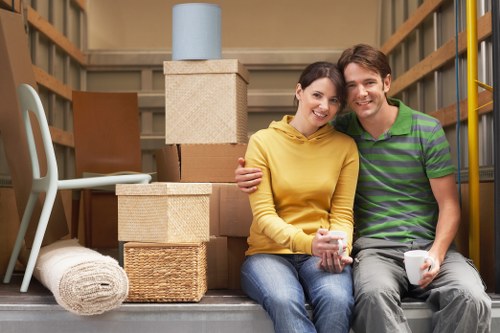 Removal company team handling household moving boxes in Maidavale