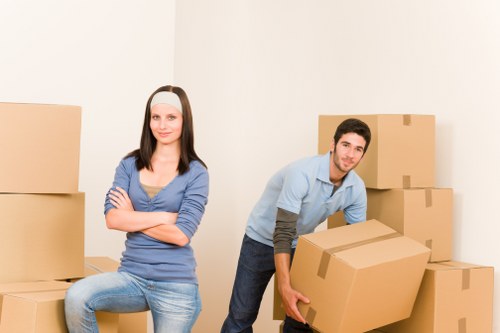 Same day moving crew loading furniture into a removal vehicle for quick delivery