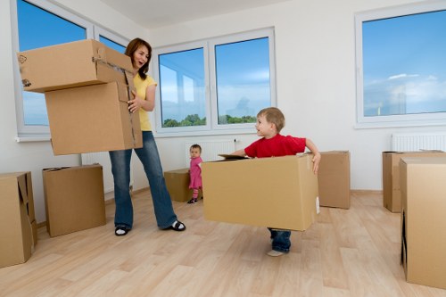 Commercial moving team supporting office relocation services in Maidavale with labeled boxes and furniture